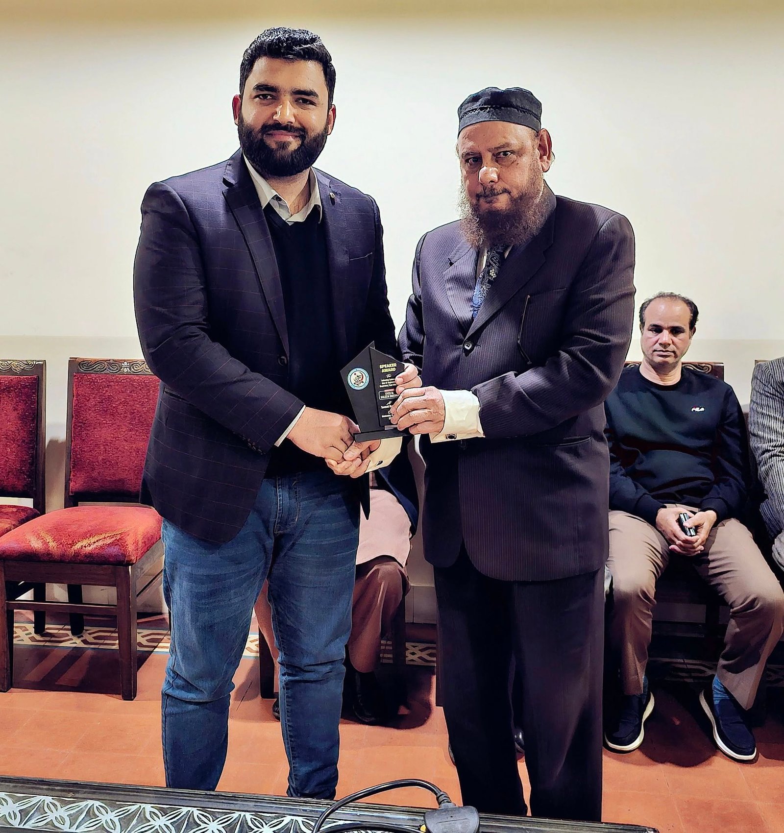Dr. Adil Rehman Ghumman receiving a speaker award